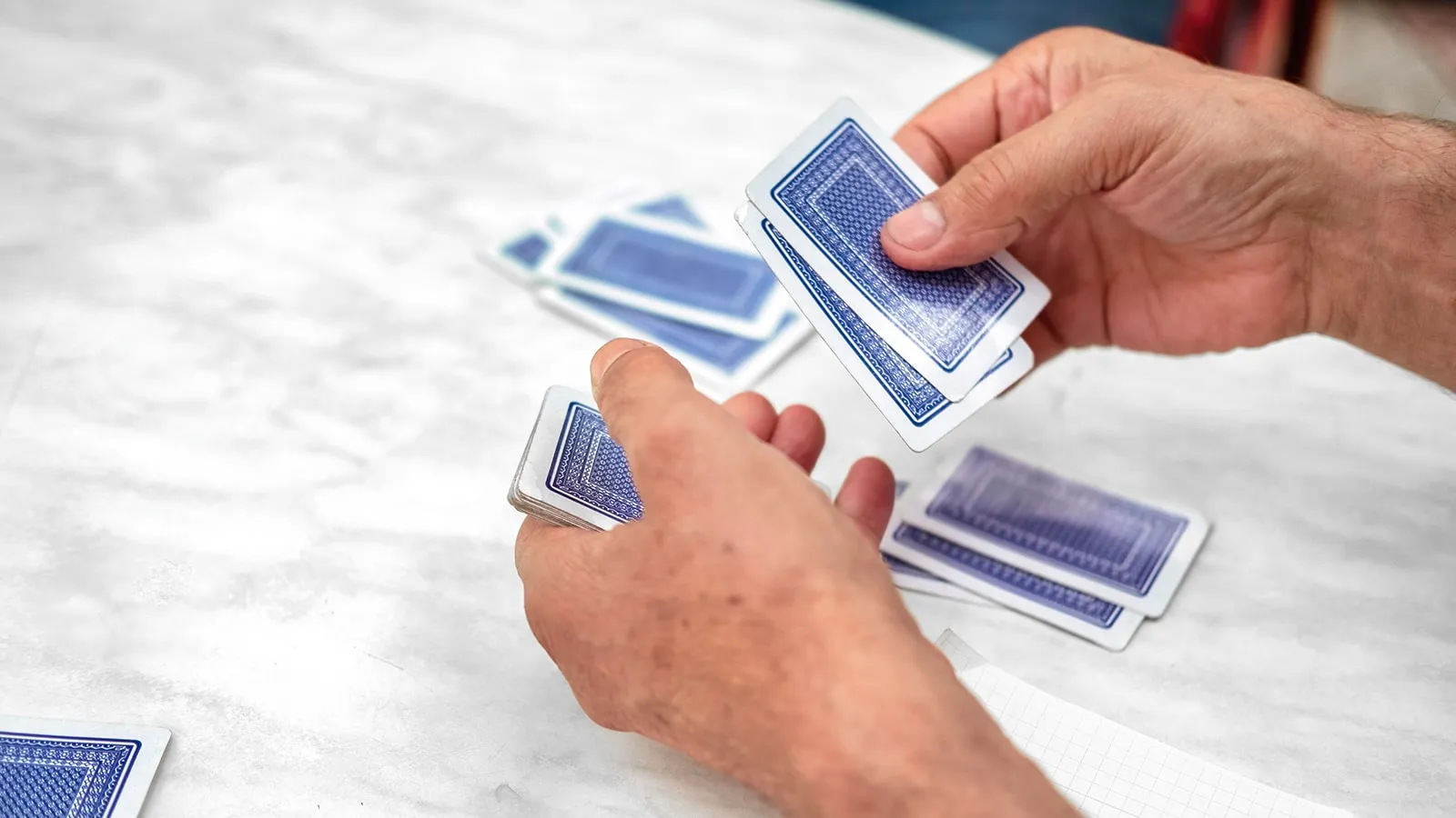 Player's hands dealing Burraco cards